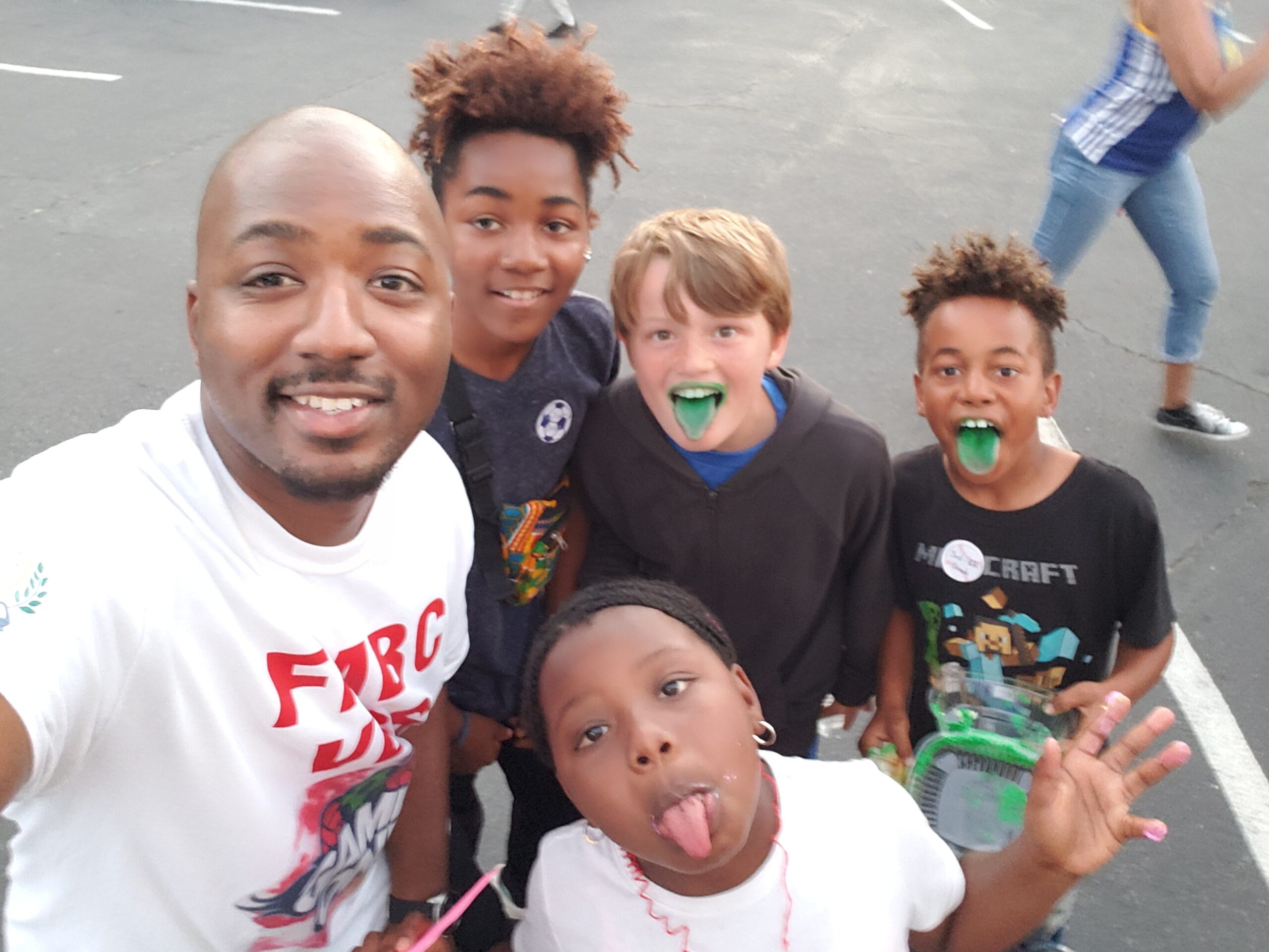 Pastor with a group of kids outside