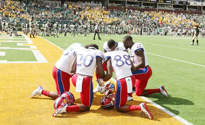 Football team in huddle - faith and sport